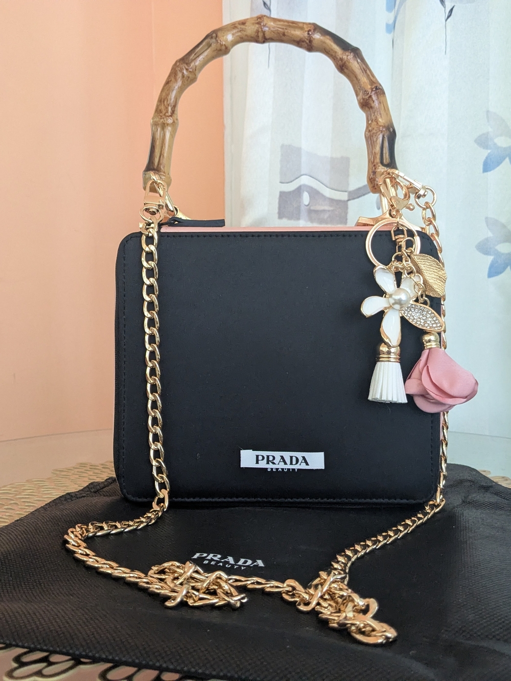 Prada Black Crossbody Bag with Bamboo Handle & Pink Flower Charm